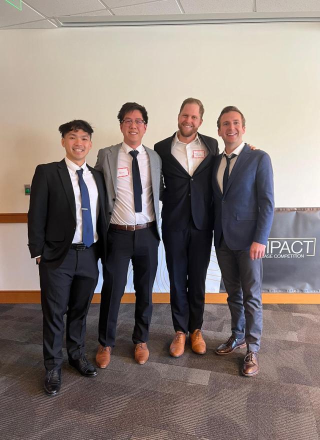 Minh Thieu Nguyen, Nic Seto, Jack Schaufler, Andrew Robert Collins dressed in professional attire at the Net Impact Case Competition